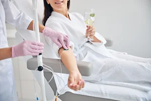 smiling female patient undergoing IV Therapy treatment